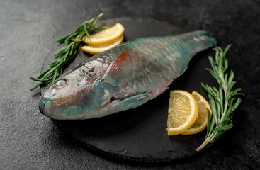 raw parrot fish on stone background