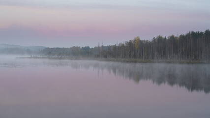 Autumn foggy morning on a lake. High quality photo