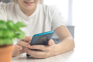 Smiling young woman use smartphone, lifestyle and leisure time, browse internet on mobile phone concept
