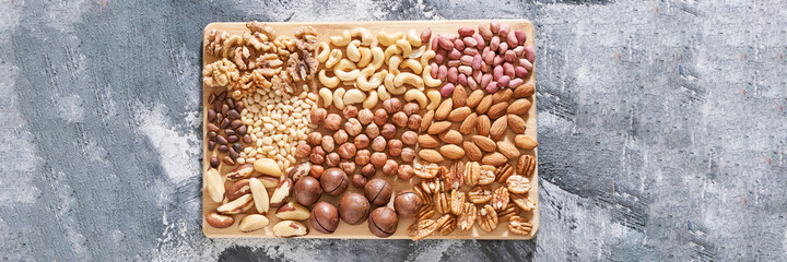 Different nuts. Home kitchen. Protein and fat food. Mix seeds. Raw whole snack or munchies. Natural cuisine. Vegan. Peanut, almond, macadamia, pine and brasil, pecan, hazelnut, cashew flatlay