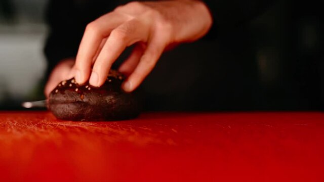 The chef prepares a burger. Beef, pork, cucumber, sauce and onion. . High quality FullHD footage