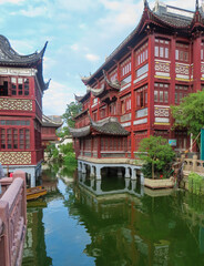 Chinese Traditional Architecture with a River and Boats next to Buildings