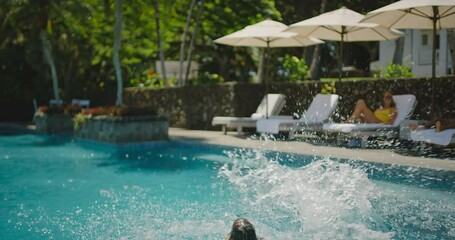 Kids jumping into the pool, family lifestyle, playing at the pool on summer vacation - Powered by Adobe