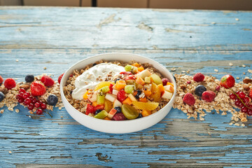 Bowl with oat and fruits prepared for breakfast