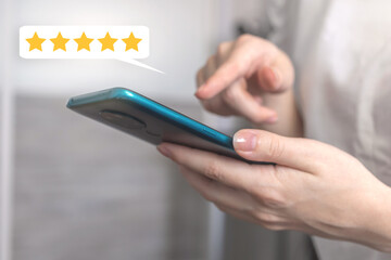 Woman touch the screen with five star rating, rate the service with feedback concept, customer with mobile phone