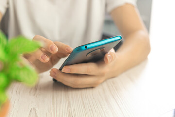 Hipster texting message on smartphone or technology, girl using mobile phone in cafe