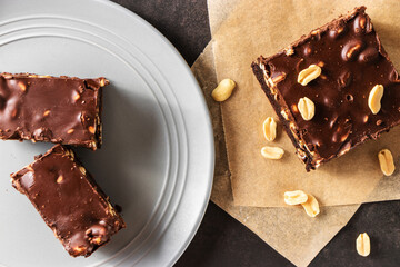 Brownie with nuts, in a gray plate top view on a gray background
