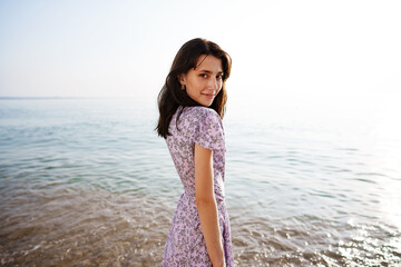 Happy woman on the beach walking by seaside