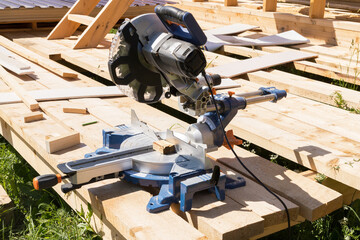 High-speed cutting circular saw. The man's hands are gloved.