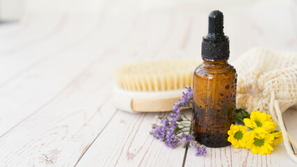 Glass bottle with cosmetic product in drops of water