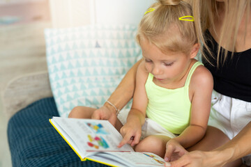 beautiful little girl reading a book 