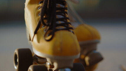 Yellow roller skates closeup. Stylish boots with wheels for skating in summer.