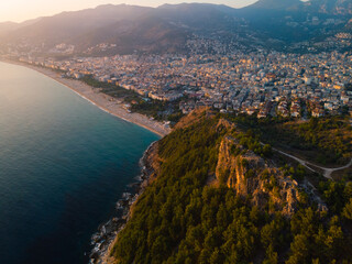 Aerial view resort city Alanya in southern coast of Turkey, Summer day. Travel and vacation. Kalesi Castle. Mountain. Ships and boats in the mediterranean
