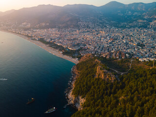 Aerial view of Kleopatra beach, lake. Alanya in southern coast of Turkey, Summer day. Travel and vacation. Kalesi Castle. Mountain. Ships and boats in the mediterranean