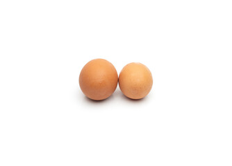 Two uncooked chicken eggs on isolated white background