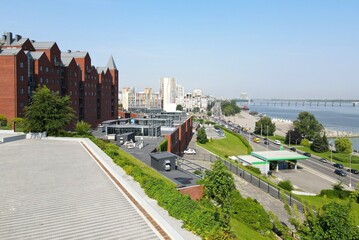 The observation deck in the park overlooks the city, red brick buildings and skyscrapers. Street in...