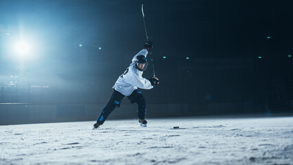 Ice Hockey Rink Arena: Professional Player Training Alone. Skates, Dribbles with Stick, Hitting the...