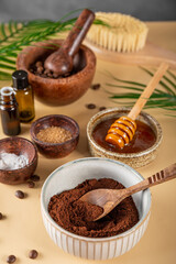 Ingredients for making homemade coffee skincare scrub on a table. Eco friendly cosmetics, vertical photo