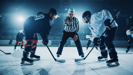 Ice Hockey Rink Arena Game Start: Two Players Brutal Face off, Sticks Ready, Referee is Going to Drop the Puck, Athletes Ready to Fight. Intense Game Wide of Energy Competition, Speed.
