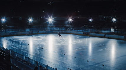 Ice Hockey Rink Arena: Professional Player Training Alone. Skates, Dribbles with Stick, Shooting,...