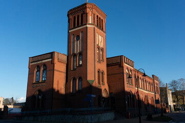 Obraz premium Post office from 1905. Evening light floods the building. Sławno, Poland.
