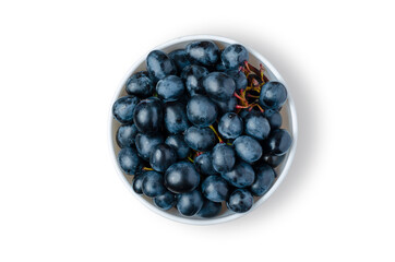 Black Grapes. Ripe berries in a white plate. Isolated on white.