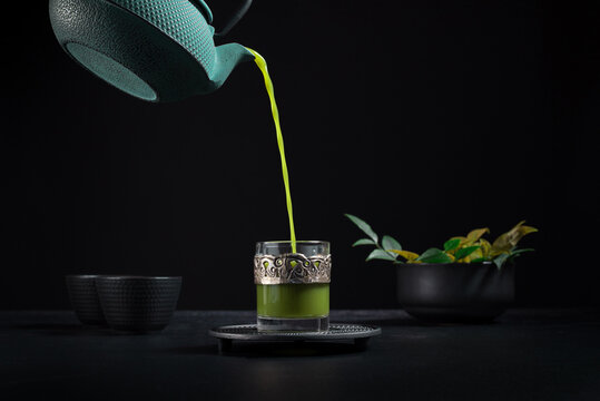 Traditional matcha tea served into cup