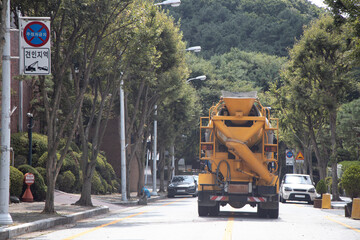 yellow ready-mixed concrete truck driving on the road