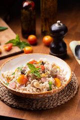 Rice salad in a bowl on wooded table