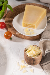Delicious parmesan cheese, tomato and basil. Fresh ingredients for cooking pasta or sauce. Italian cuisine concept.