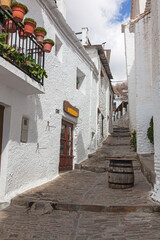 Picturesque facades of ancient houses in white village Las Alpujarras, Granada Province, Spain