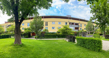 Fototapeta na wymiar Residential area with ecological and sustainable green residential buildings, low-energy houses with apartments and green courtyard