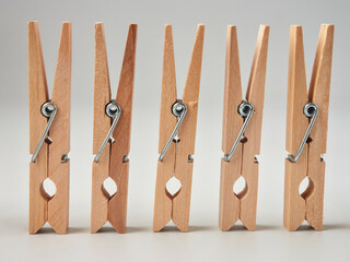 Set of wooden clothes pins on white background