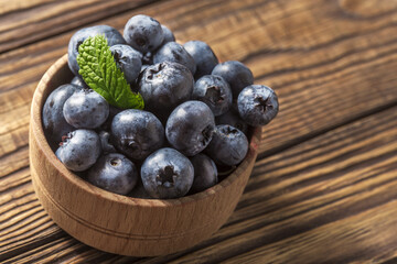 healthy blueberries on the table in a wooden bowl