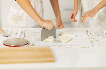 Female preparing dough  on board in kitchen