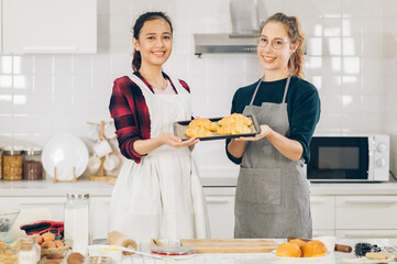 Smile two women dough bake cookies in kitchen