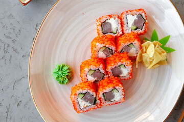 California roll with tuna Japanese cuisine in plate on gray table
