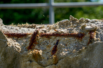 Rusty structural steel and flaking concrete parts on a bridge