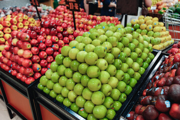 Stall with red and green fresh apples in supermarket