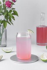 Pink ombre drink, ombre cocktail in a glass, Grapefruit juice in a glass, pink grape juice in a can shaped glass 