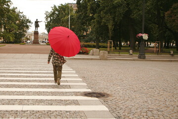 young girl with red umbrella in the city