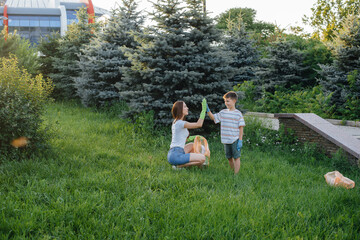A group of girls with children at sunset are engaged in garbage collection in the park....
