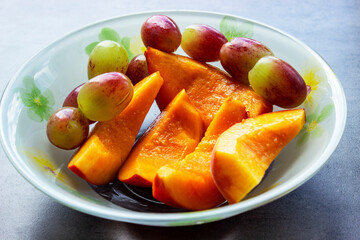 Salad with peaches, goat cheese, plum and basil, selective focus