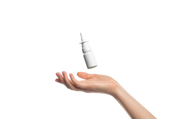 Nasal spray hovering or flying over a woman's hand, isolate