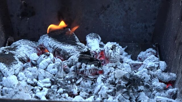 Charcoal and flame of fire in the outdoor brazier. 
