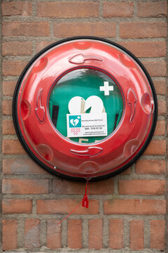 Eindhoven, The Netherlands, June 28th 2021. Defibrillator AED on a brick wall in public space for emergency heart resuscitation in emergency situations such as acute cardiac arrest