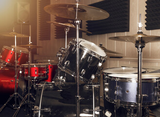 Drumkit in red and silver colors with drums and cymbals.
