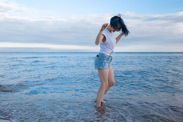 Active healthy young woman enjoying a sandy baltic beach.