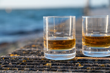 Drinking single malt Scotch whisky at sunset with sea, ocean or river view, private whisky tours in Scotland, UK