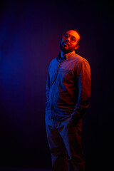 Neon Light hispanic Portrait in trendy outerwear and sunglasses